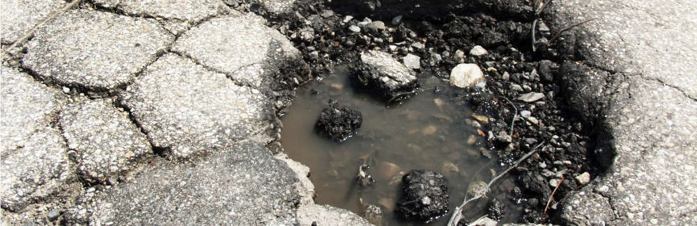 Pothole in road after spring thaw